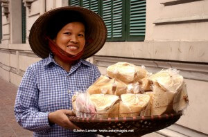 One of the most endearing sights of Hanoi is that of its ubiquitous vendors peddling baskets of crackers, fruit or baguettes through the streets. Whether sold from the back of a bicycle or baskets balanced on bamboo shoulder poles street vendors are a part of the Hanoi scene.